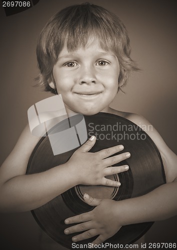 Image of boy with a record smiles