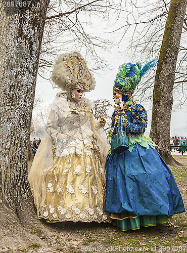 Image of Two People Disguised Discussing