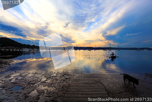 Image of Rowboat coming to shore in late afternoon sunset