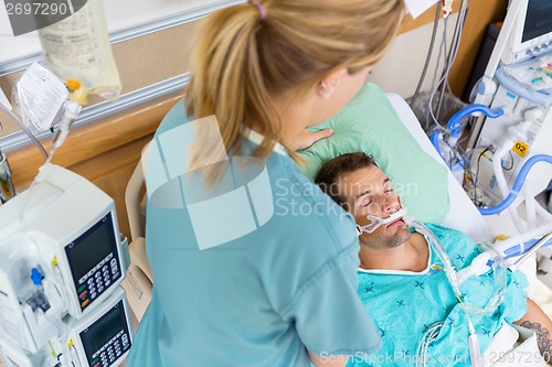 Image of Nurse Adjusting Patient's Pillow