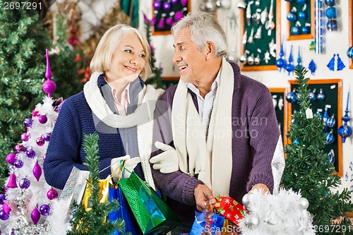 Image of Happy Senior Couple Shopping In Christmas Store