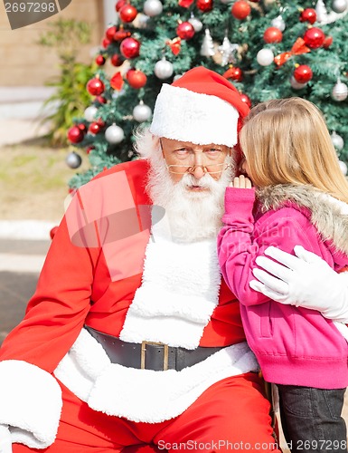 Image of Girl Telling Wish In Santa Claus's Ear