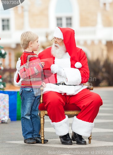 Image of Boy Giving Wish List To Santa Claus