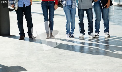 Image of College Students Standing In A Row On University Campus