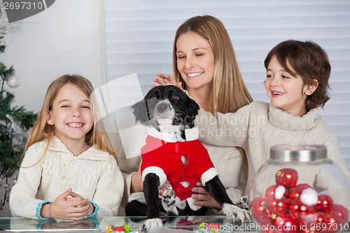 Image of Family With Pet Dog At Home During Christmas