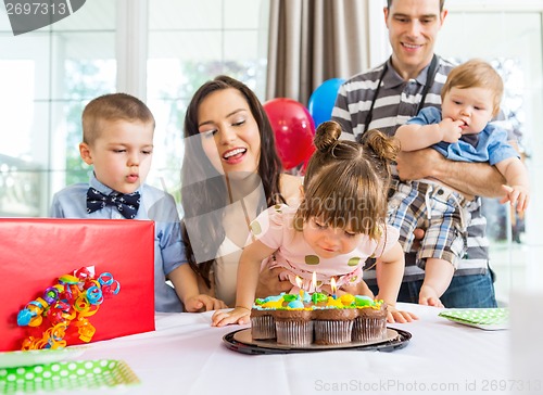 Image of Girl Blowing Out Candles On Birthday Cake
