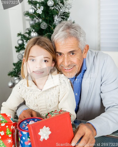 Image of Girl And Grandfather With Christmas Gifts