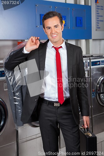 Image of Businessman With Suitcase And Suitcover In Laundry