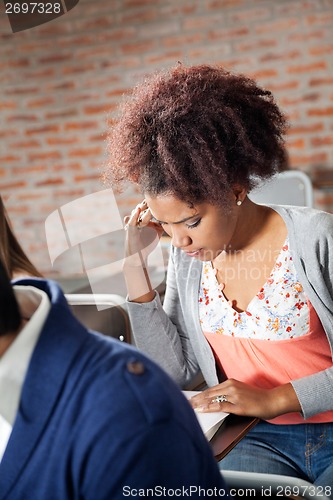 Image of Student Thinking While Giving Exam In Classroom