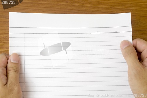 Image of Hand holding blank writing paper

