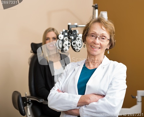 Image of Female Optometrist With Patient In Background