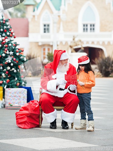 Image of Girl And Santa Claus With Wish Letter