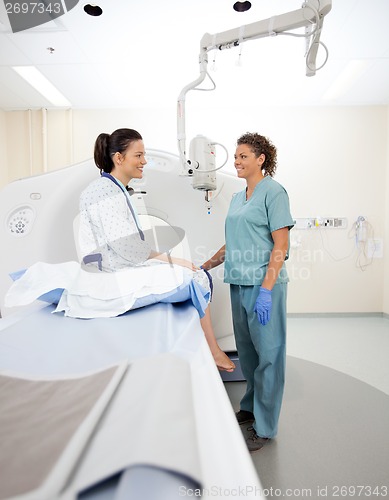 Image of Nurse With Patient In CT Scan Room