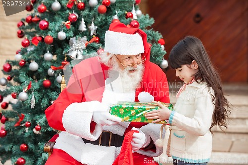 Image of Girl Taking Gift From Santa Claus