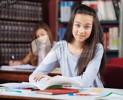 Image of Beautiful Teenage Schoolgirl With Books Sitting In Library