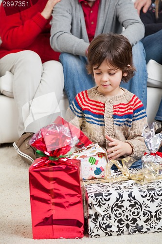 Image of Boy Looking At Christmas Presents