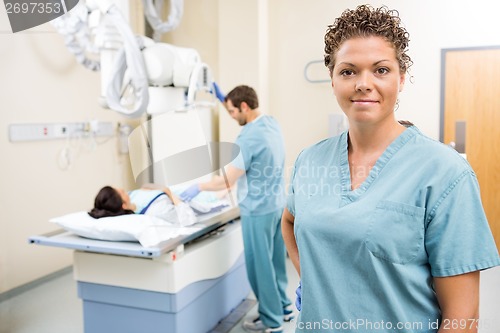 Image of Medical Team With Patient In Examination Room