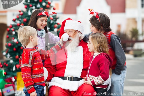 Image of Children Playing With Santa Claus's Hat