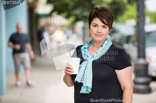 Image of Woman With Disposable Coffee Cup On Pavement