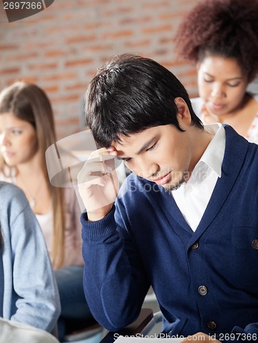 Image of Student Thinking With Classmates In Classroom