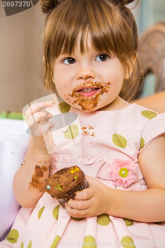 Image of Girl Eating Birthday Cake With Icing On Her Face