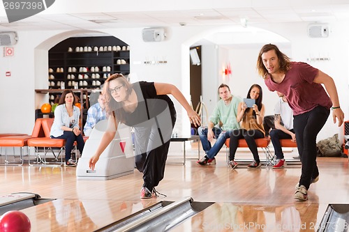 Image of Man And Woman Playing in Bowling Alley