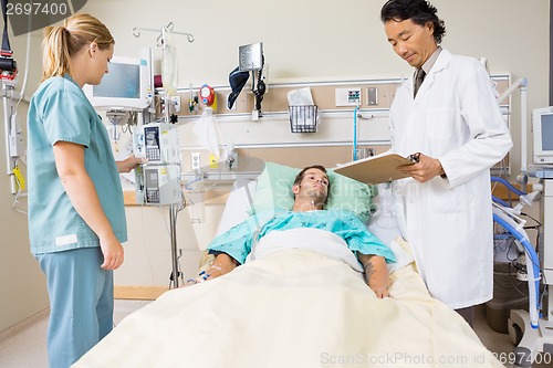 Image of Doctor Examining Patient's Report