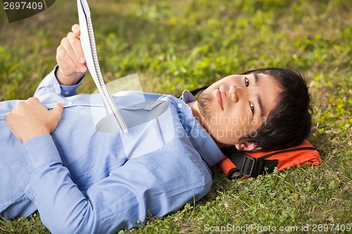 Image of Student With Book Lying On Grass At University Campus