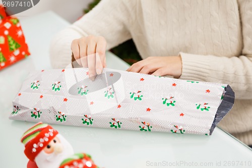 Image of Woman Wrapping Christmas Gift