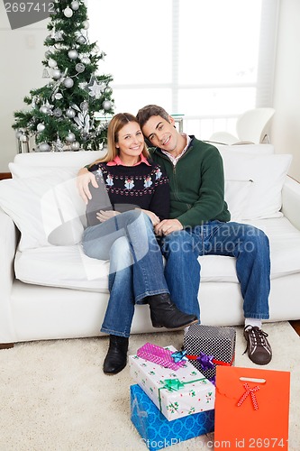 Image of Couple With Christmas Presents On Floor