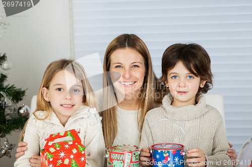 Image of Happy Mother And Children With Christmas Gifts