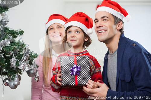 Image of Parents With Boy Holding Christmas Present