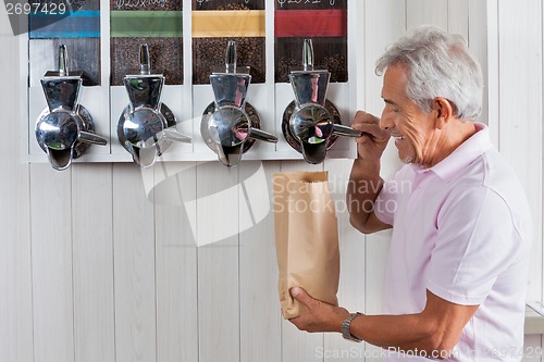 Image of Senior Man Buying Coffee Beans At Grocery Store