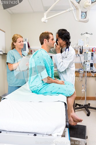 Image of Doctor With Ophthalmoscope Examining Patient's Eye In Hospital