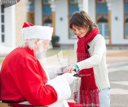 Image of Boy Taking Biscuits From Santa Claus