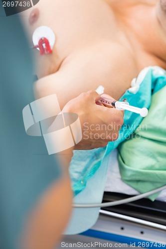 Image of Nurse Injecting Patient On Arm In Hospital