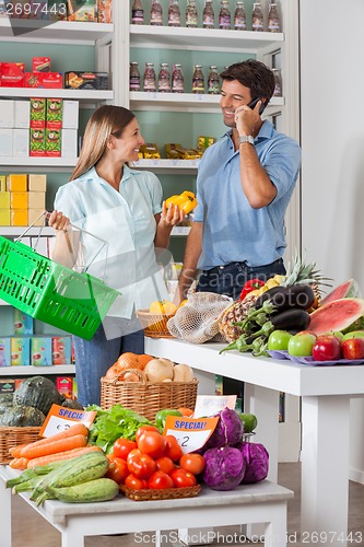 Image of Couple Shopping Vegetables In Supermarket