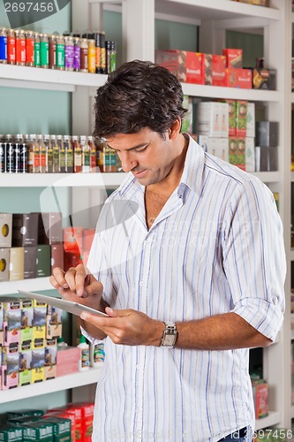 Image of Man Using Tablet In Store