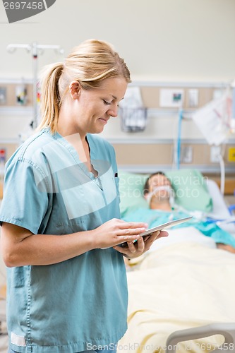 Image of Nurse Using Digital Tablet In Hospital