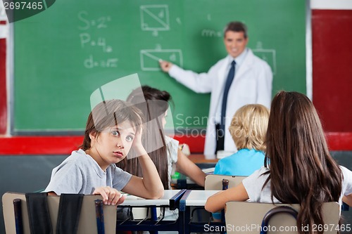 Image of Portrait Of Young Schoolboy Leaning At Desk