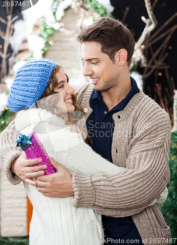 Image of Romantic Couple Embracing At Christmas Store