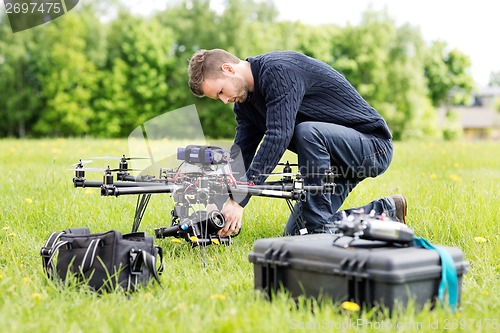 Image of Engineer Setting Camera On UAV Helicopter