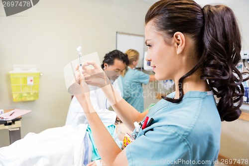 Image of Medical Team Treating Patient In Hospital