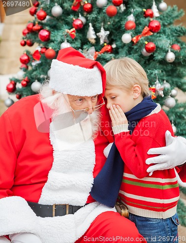 Image of Boy Telling Wish In Santa Claus's Ear