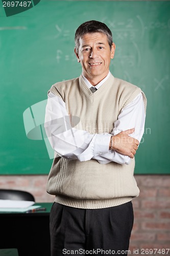 Image of Professor Standing Arms Crossed In Classroom