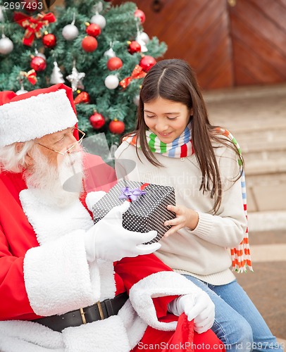 Image of Girl Taking Christmas Gift From Santa Claus