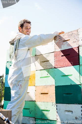 Image of Beekeeper Loading Stacked Honeycomb Crates