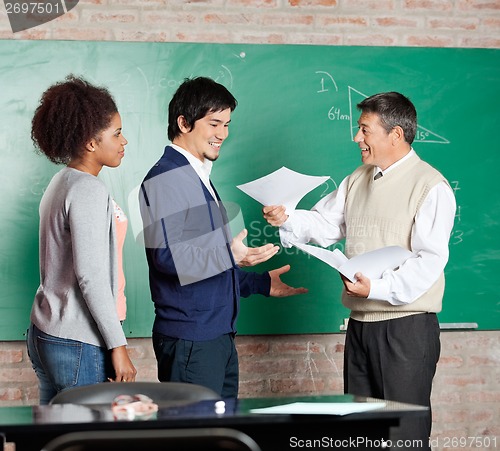 Image of Professor Giving Test Result To Male Student At Classroom