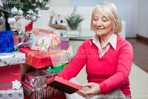 Image of Senior Woman Looking At Christmas Gift