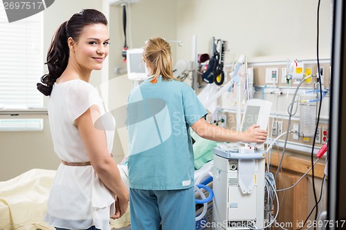 Image of Woman With Nurse Examining Patient In Hospital